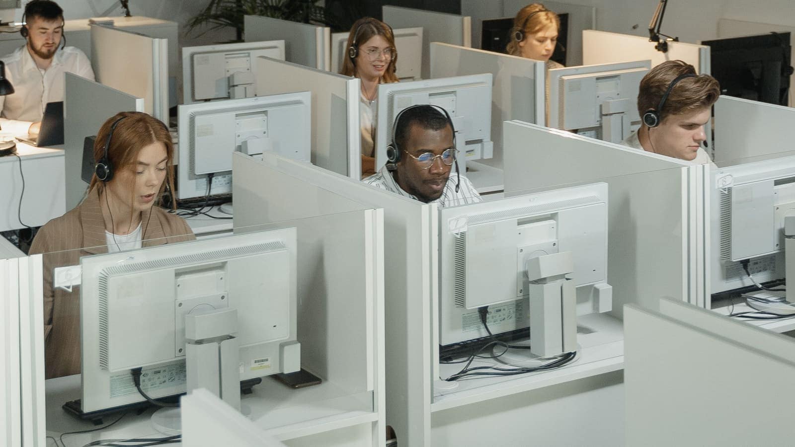 CrossShore inbound customer support floor with agents handling voice, chat and email queues on a 24/7 rostered shift