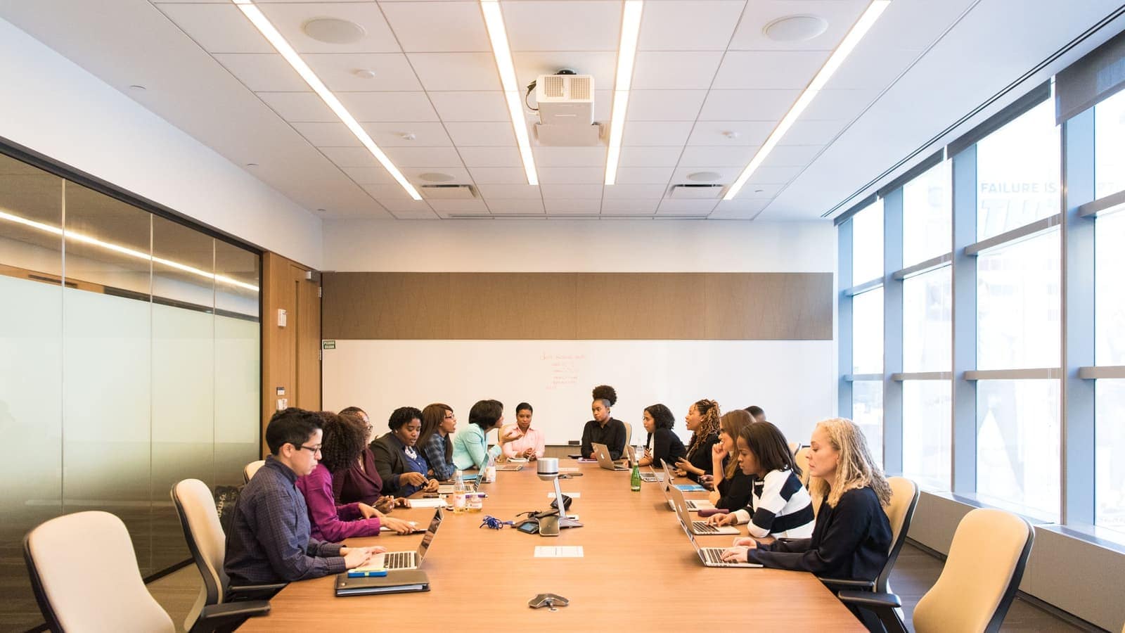 Buyers reviewing call center outsourcing research and vendor diligence material around a boardroom table